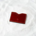 Berling Heirloom Crimson card holder, Shell Cordovan, red - top view in snow
