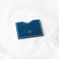 Berling Heirloom Lapis card holder, Shell Cordovan, blue - top view in snow
