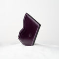 Berling Heirloom Tyrian card holder, Shell Cordovan, purple - front view, standing in snow
