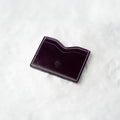 Berling Heirloom Tyrian card holder, Shell Cordovan, purple - top view in snow